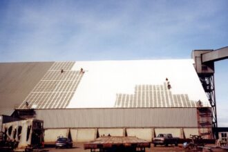 men working on big building roof