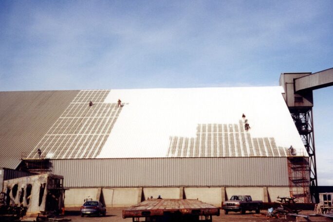 men working on big building roof