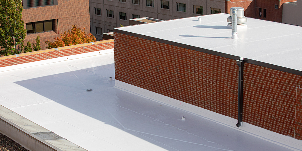 White rubber roof coating on a flat roof