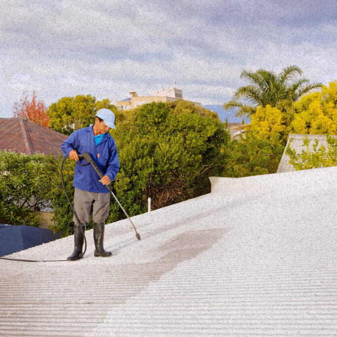 gentleman spraying roof with chemical