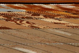 A picture of a very rusted metal roof in need of restoration.