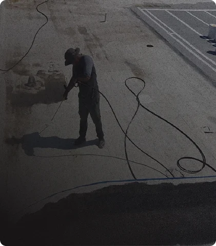 gentleman spraying roof with dark overlay