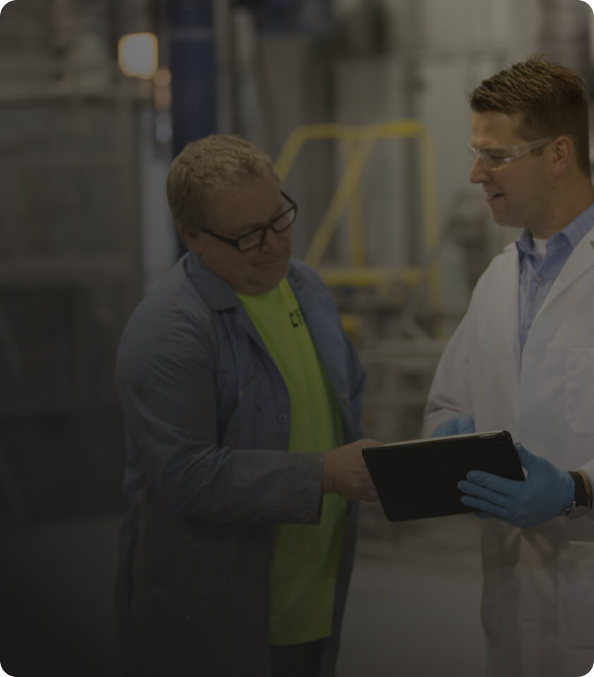 two employees going over information with dark overlay