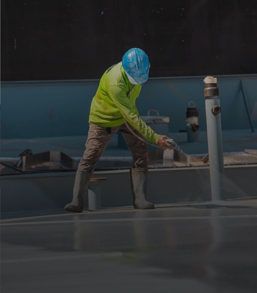 contractor applying roof coating